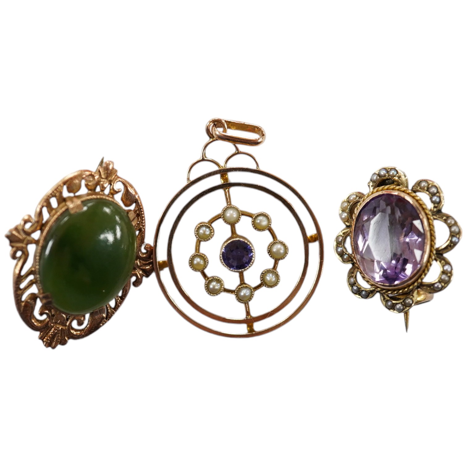 An Edwardian 9ct, sapphire and seed pearl cluster set open work circular pendant, 26mm, together with a similar 9ct, amethyst and seed pearl set brooch and a 9ct and nephrite set brooch, gross weight 7.4 grams. Condition